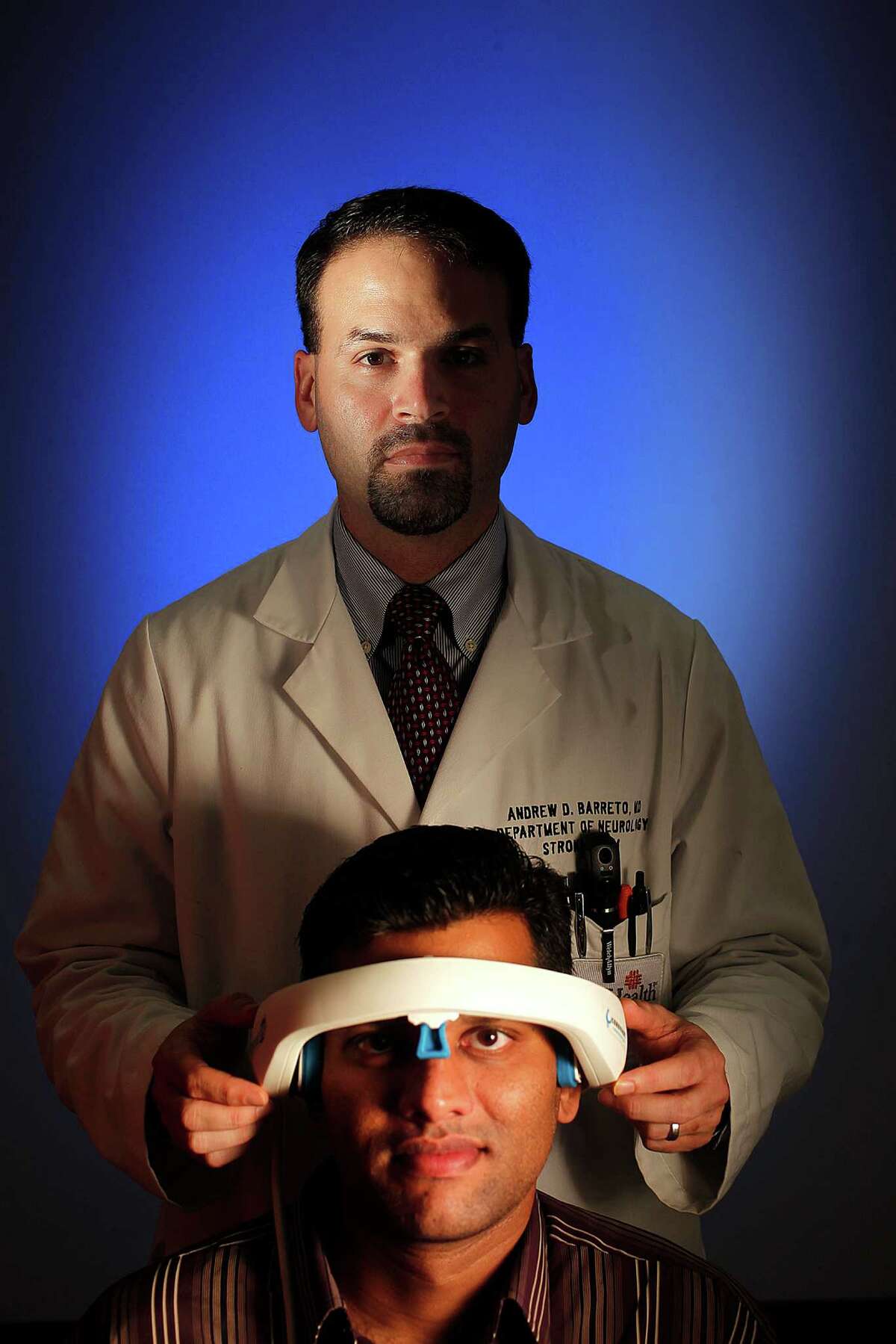 Dr. Andrew Barreto and research assistant Hari Indupuru show off the ClotBust-ER.