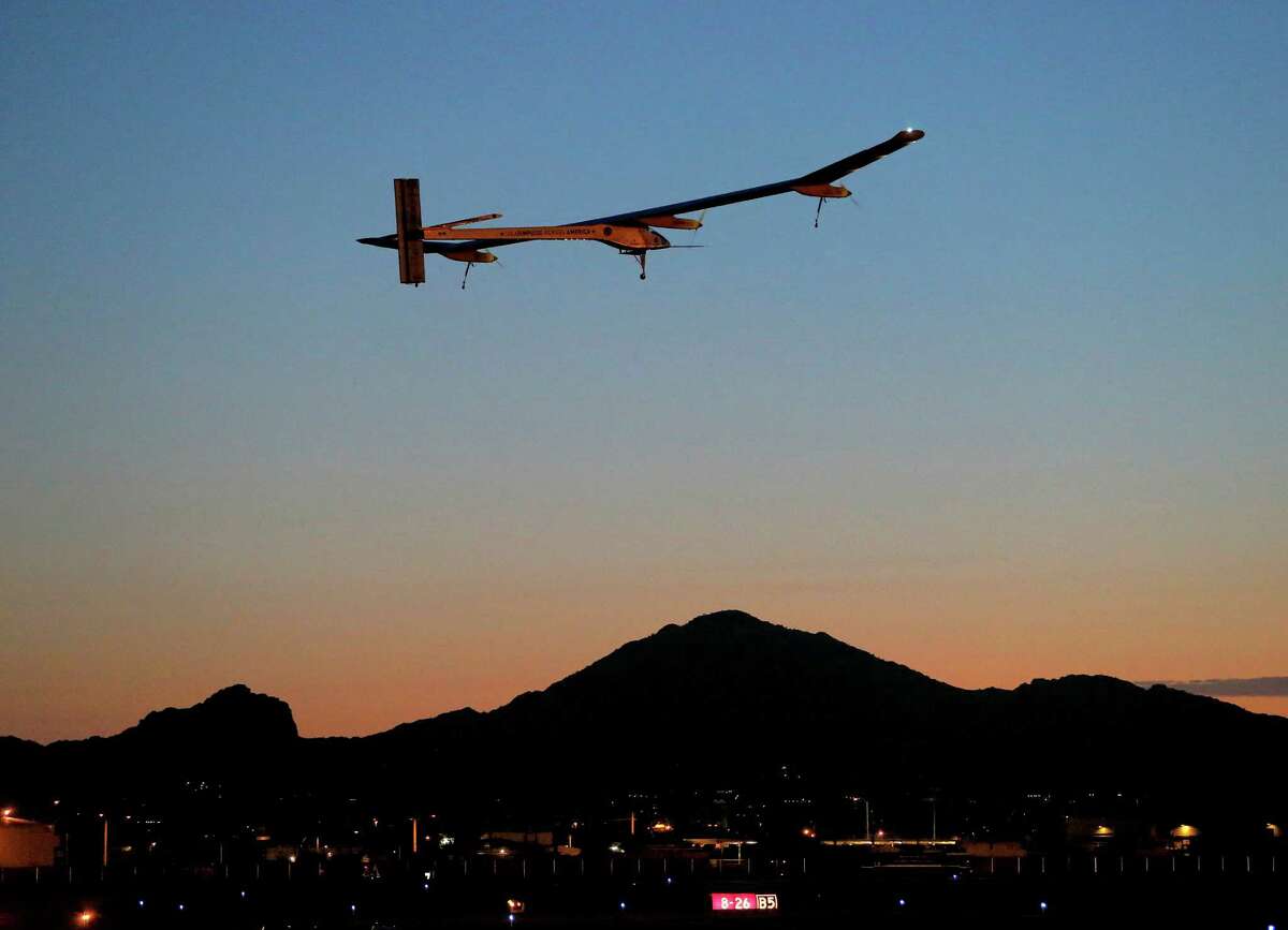 FILE - This May 22, 2013 file photo shows the Solar Impulse, piloted by AndrÃ© Borschberg, taking flight, at dawn, from Sky Harbor International Airport in Phoenix. The spindly no-fuel plane called Solar Impulse is scheduled to leave Washington Saturday early in the morning and arrive after midnight at New York's John F. Kennedy International Airport. It may silently buzz the Statue of Liberty on the way. The plane started its cross-country journey May 3 from San Francisco. (AP Photo/Matt York)