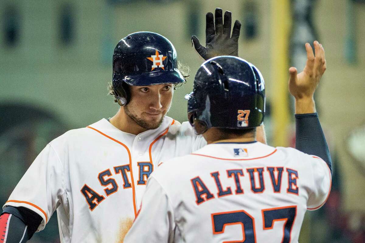 Brett Wallace, left, gave the Astros reason to celebrate with an eighth-inning homer, his second of the game, that tied Thursday's game at 5. Jose Altuve was one of two other Astros to score on the homer off Joel Peralta.