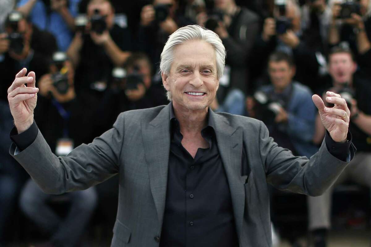 (FILES) Photo dated May 21, 2013 shows US actor Michael Douglas during a photocall for the film "Behind the Candelabra" at the Cannes Film Festival. Douglas said he would win a Nobel prize if he knew exactly what caused his throat cancer, in fresh comments on June 4, 2013 after a dispute with a British newspaper over an interview he gave. The "Fatal Attraction" star, whose spokesman already denied he blamed his throat cancer specifically on oral sex, also said that, regardless, he was happy to raise awareness about causes of the killer disease. AFP PHOTO/FILES/VALERY HACHEVALERY HACHE/AFP/Getty Images