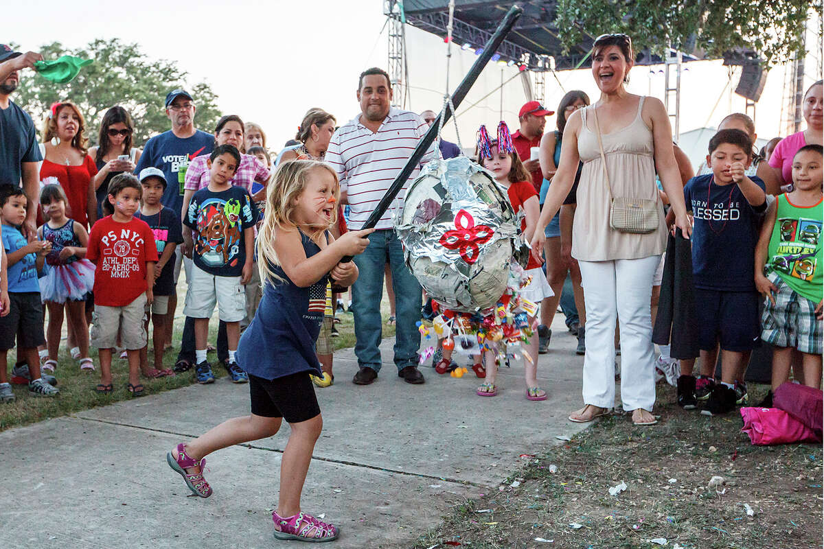 Candy begins to spill as Scarlet Rogers, 6, breaks a pinata at the Cornerstone Church's Fourth of July celebration. The event featured food, children’s activities, live music and a fireworks show.