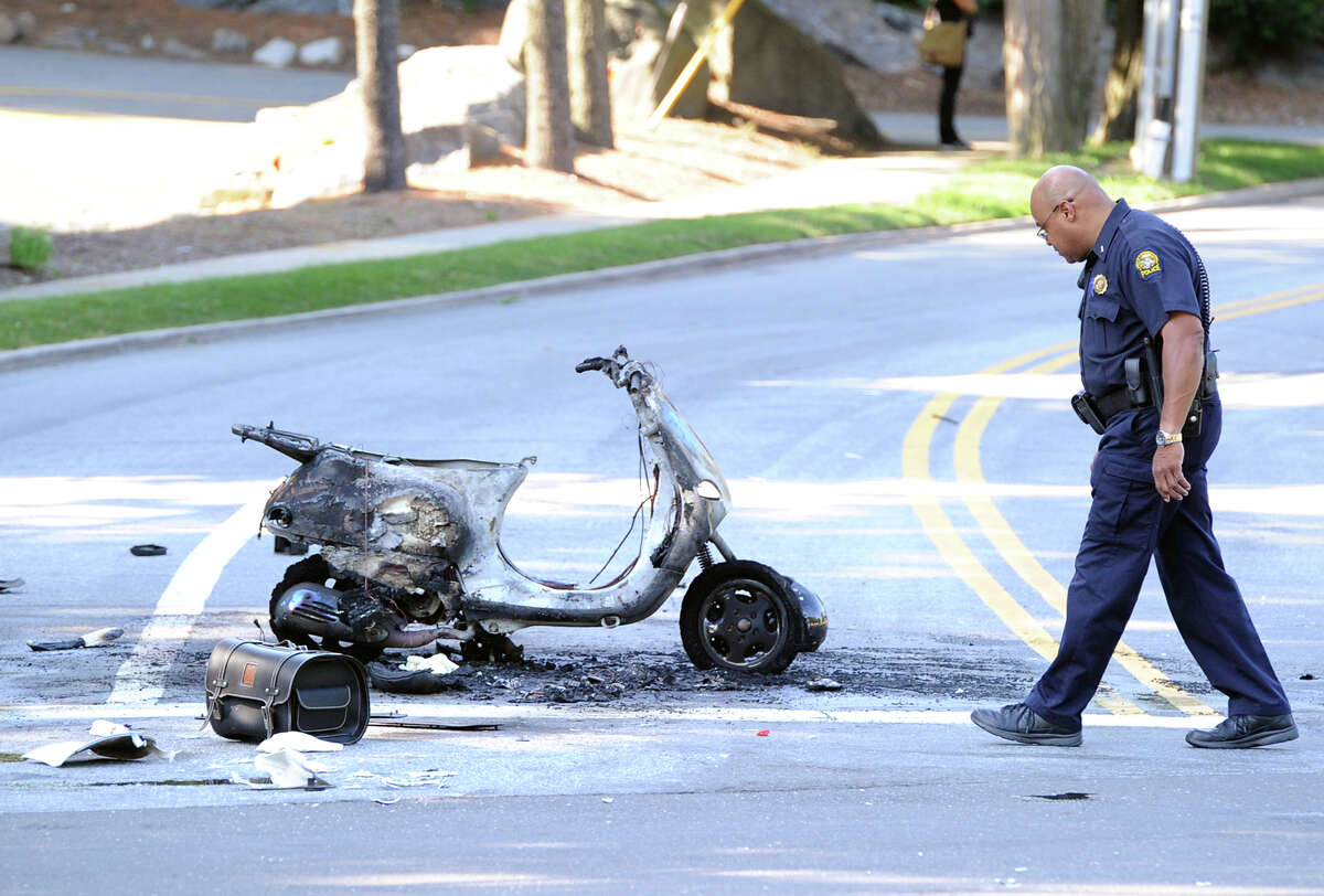 Greenwich police investigate the scene of an accident in which a moped was incinerated at the corner of Valley Drive and West Putnam Avenue in Western Greenwich, Friday, July 5, 2013.