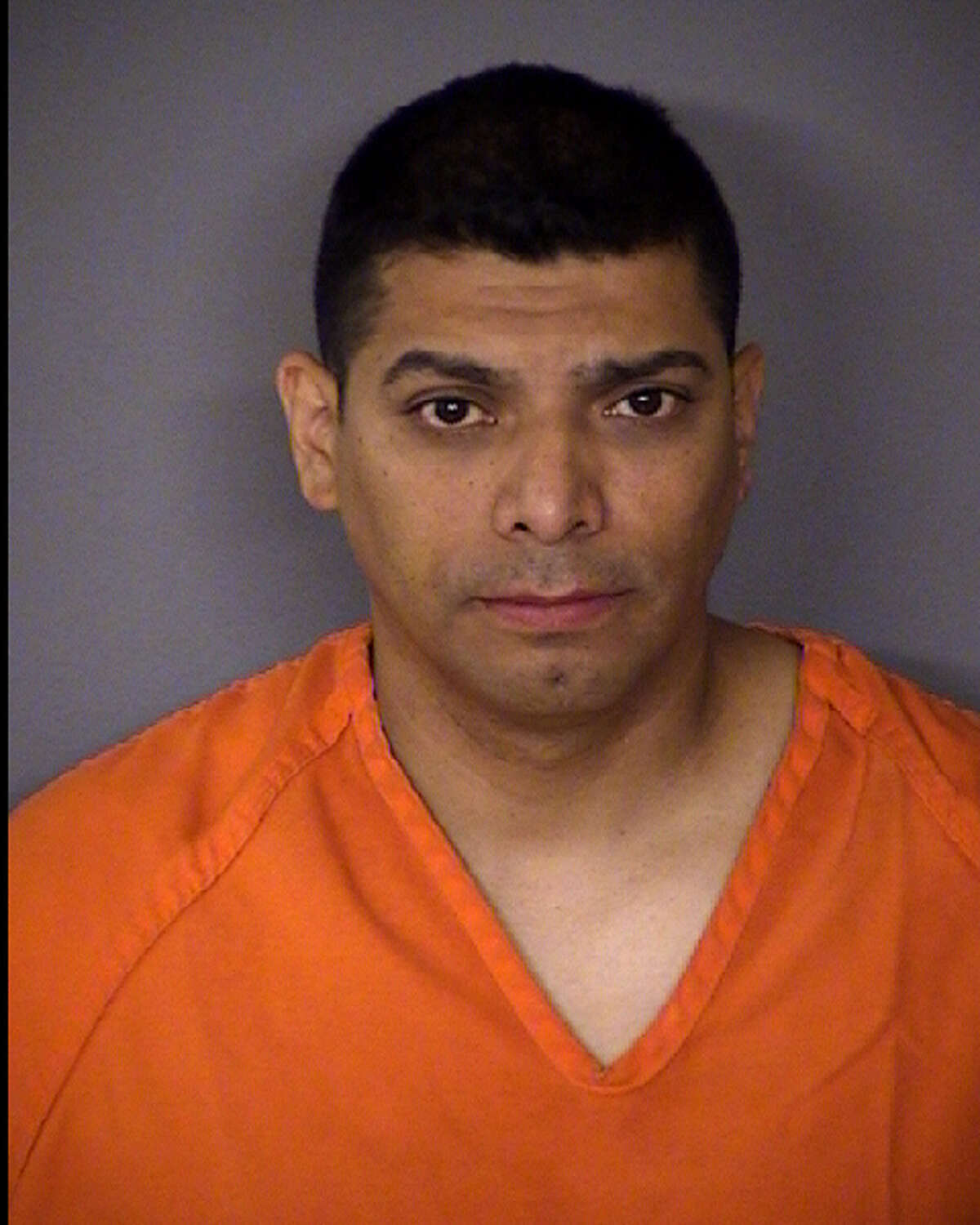 SAPD Officer Daniel Lopez, 42, seen in a July 5, 2013 booking photo provided by the Bexar County Sheriff's Department was arrested at 11:54 p.m. on July 4, 2013 and charged with aggravated assault with a deadly weapon and two counts of deadly conduct following a short standoff at his house in the 100 block of Whitecliff. Lopez allegedly pointed a gun at his wife.