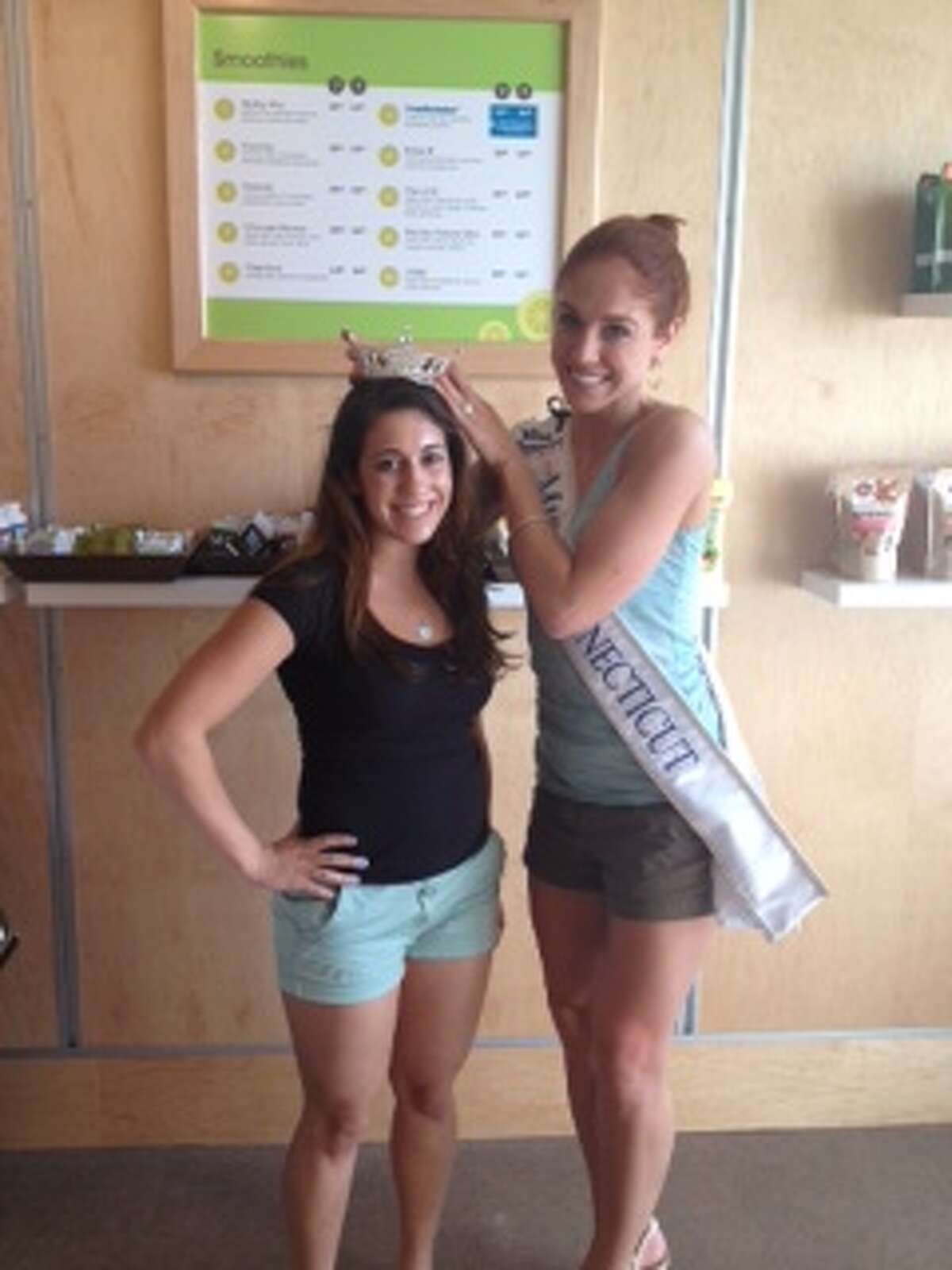 Miss Connecticut Kaitlyn Tarpey (right), poses with a customer at Green & Tonic in Darien on Friday, June 28.