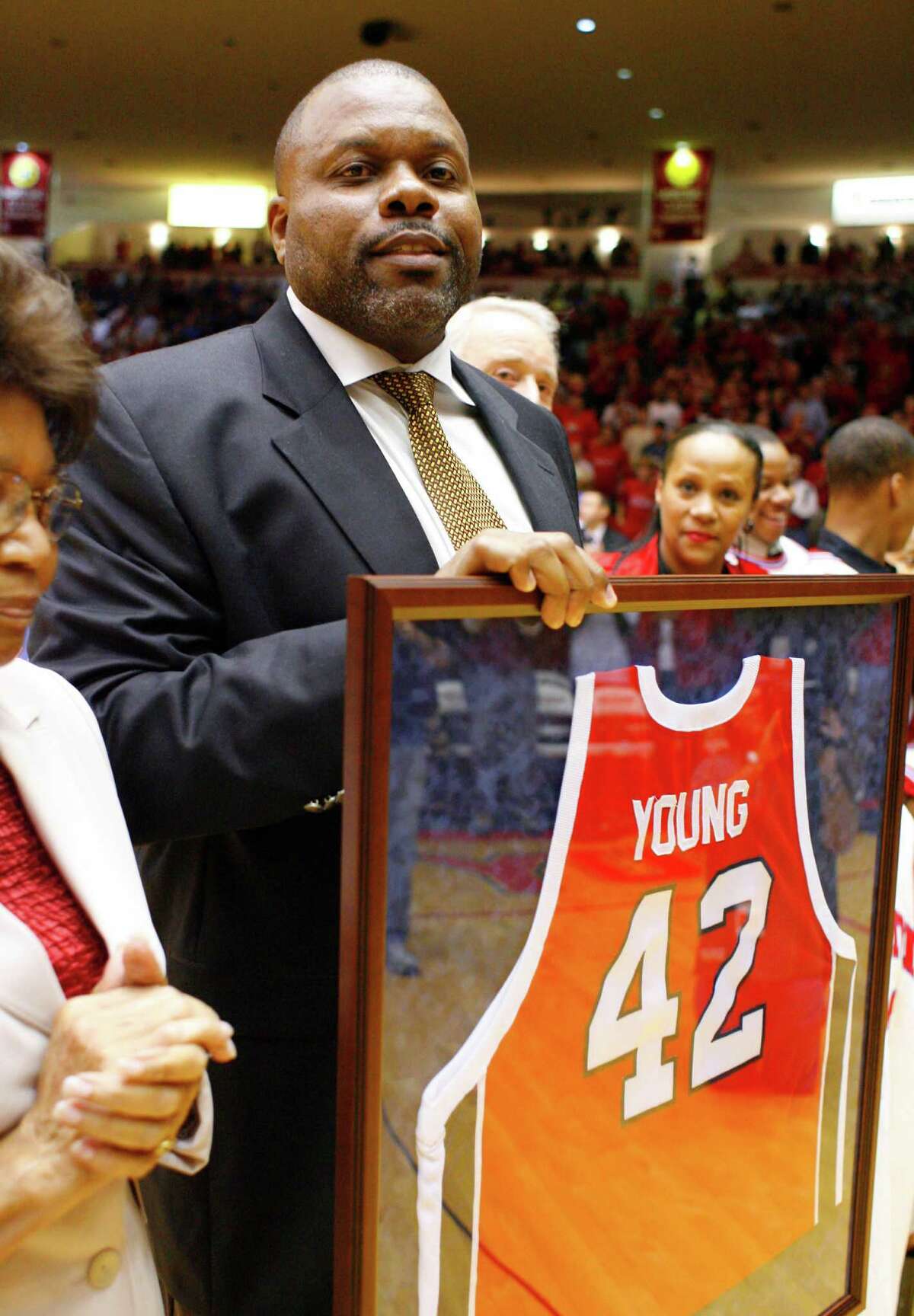 Michael Young holds his framed jersey after his number was retired during half-time of the University of Houston v Kentucky basketball game, Tuesday, at Hofheinz Arena. Tuesday, Dec. 18, 2007, in Houston. (Steve Ueckert / Chronicle)