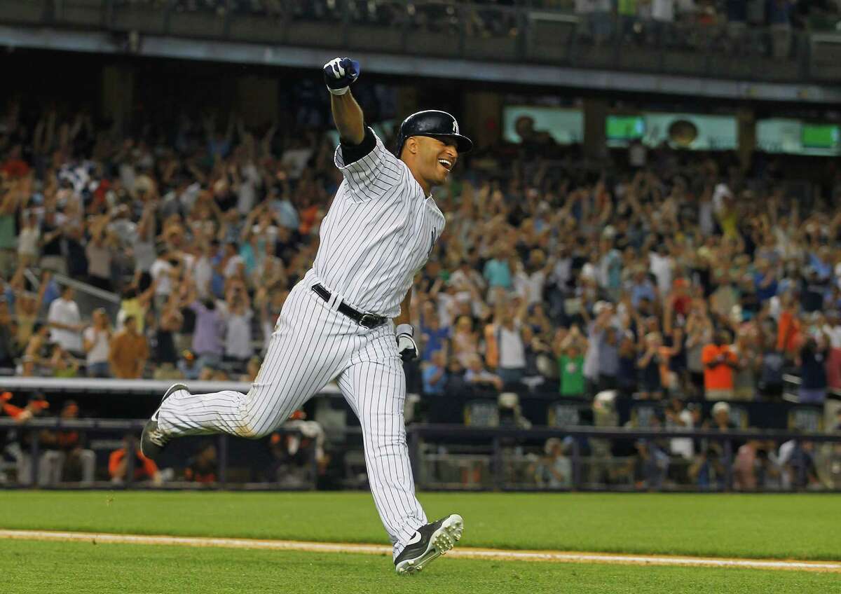 The Yankees' Vernon Wells raises his arm in triumph after hitting a walk-off single in the ninth inning to propel New York to a come-from-behind 3-2 win over the Baltimore Orioles on Friday at Yankee Stadium.