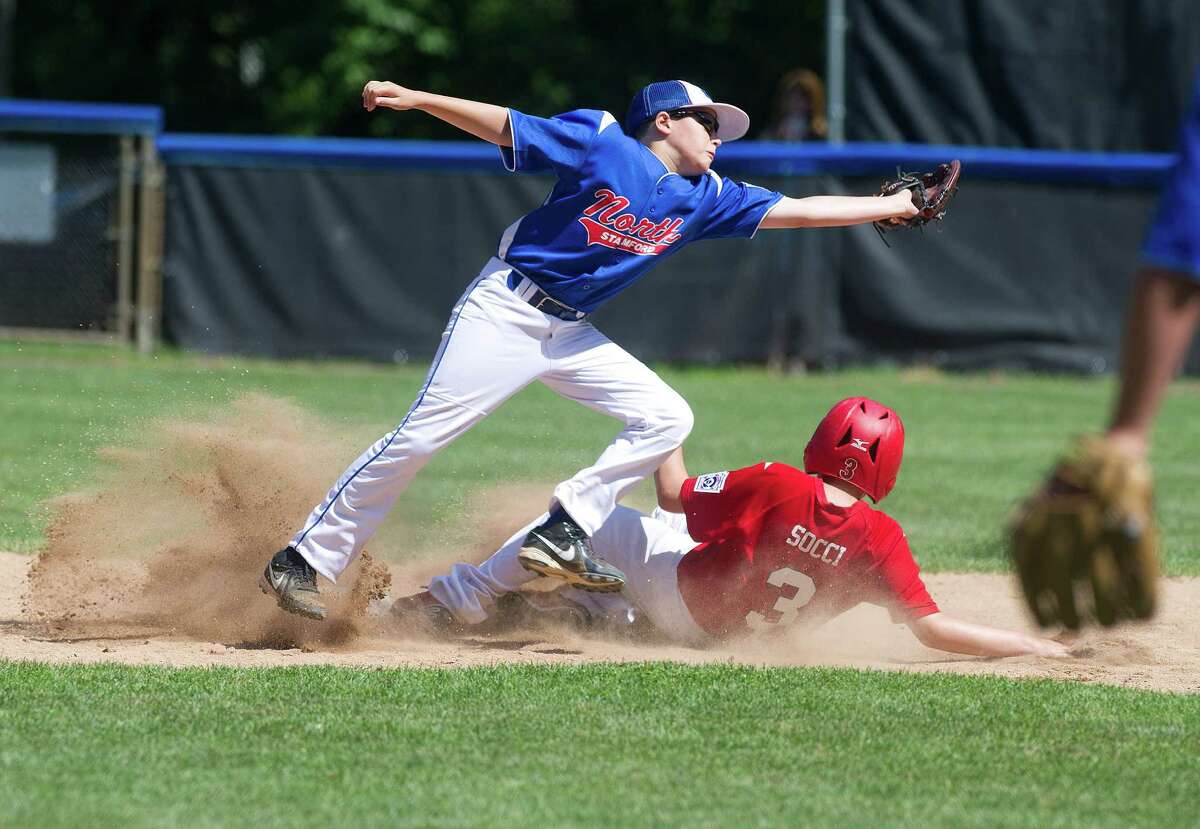Stamford American's Leo Socci is safe at second base as North Stamford's Noah Skaug reaches for the ball on the double play attempt during Saturday's Little League quarterfinal game at Chestnut Hill Park in Stamford, Conn., on July 6, 2013.