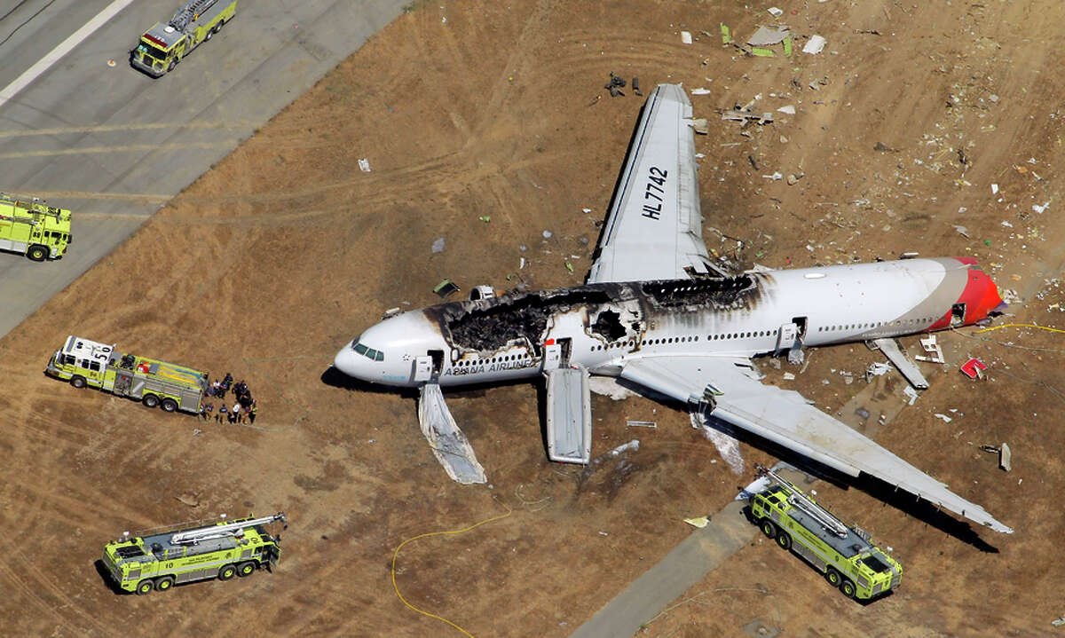 The destroyed fuselage of Asiana Airlines Flight 214 is visible on the SFO runway after the July 2013 crash that killed three.