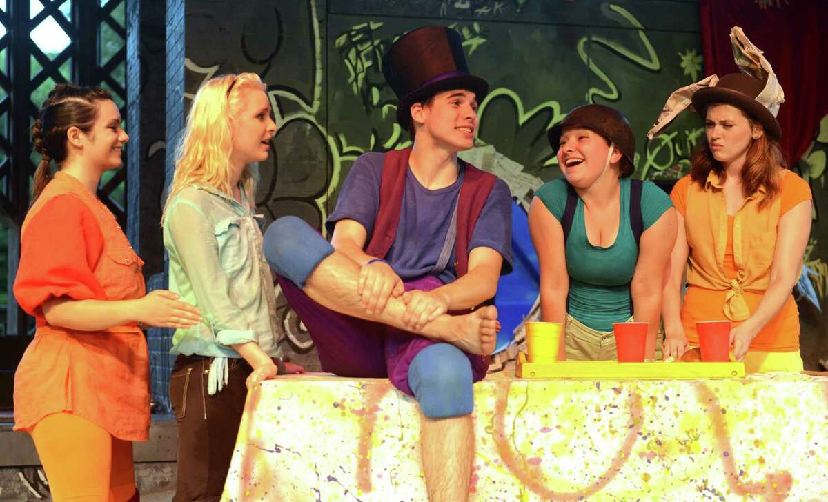 From left, Katrina Sebastian, Kera Lalli playing Alice, Jim Goggin playing the Mad Hatter, Frankie Marcille, and Nicole Curriel act out a scene during Western Connecticut State University's presentation of "Alice in Wonderland" at Ives Concert Park in Danbury, Conn. on Saturday, July 6, 2013. The show was the first of a double feature, coupled with the monologue "War Stars: An Unauthorized Parody," and kicked off the Ives Concert Park Fine Arts and Family Series.