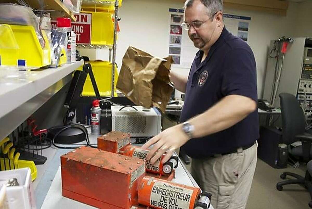 The NTSB's Greg Smith prepares to examine the cockpit voice recorder and black box data recorder from Asiana Flight 214.