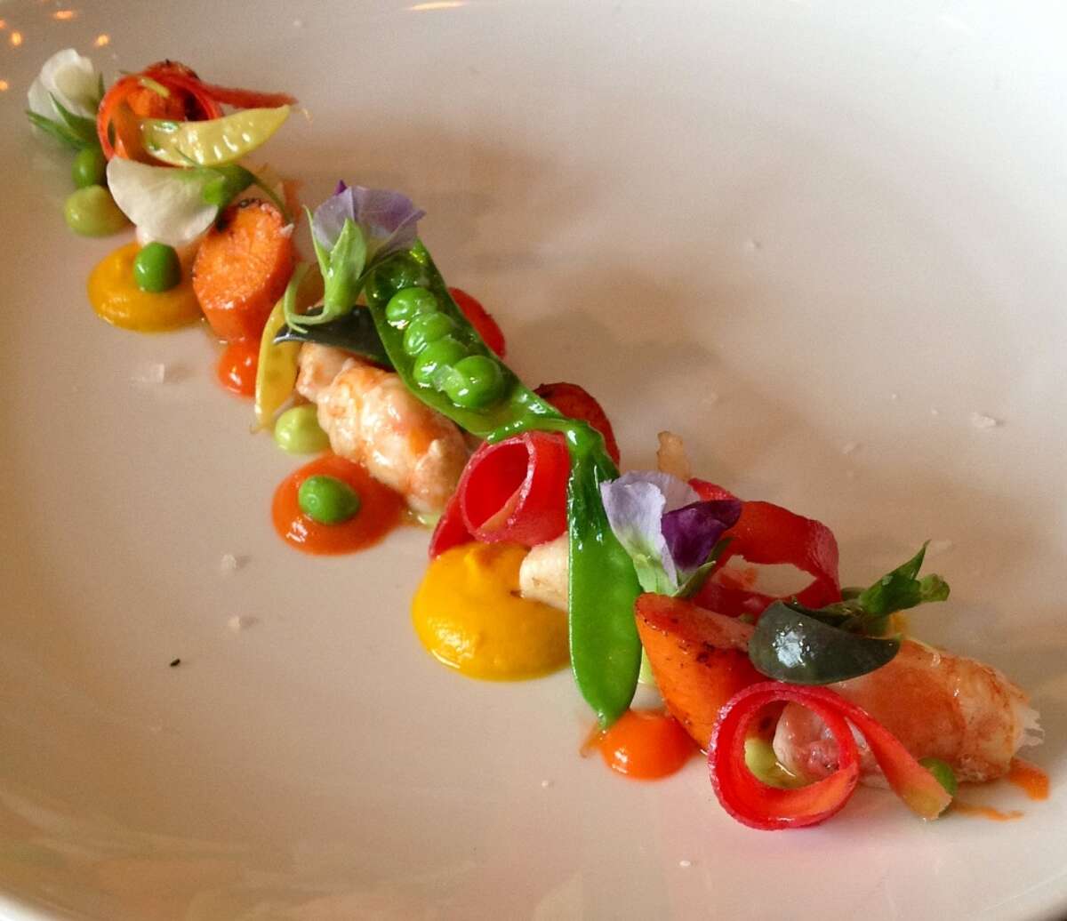 Spot prawns, roasted carrots, snap peas, English peas, pea blossoms and flash pickled black carrots at Uchi Houston.