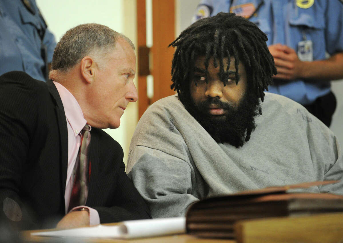 Defendant Tyree Lincoln Smith, right, makes eye contact with his attorney, public defender Joseph Bruckmann, after hearing the not guilty by reason of insanity verdict during his murder trial in state Superior Court in Bridgeport, Conn. on Tuesday, July 9, 2013.