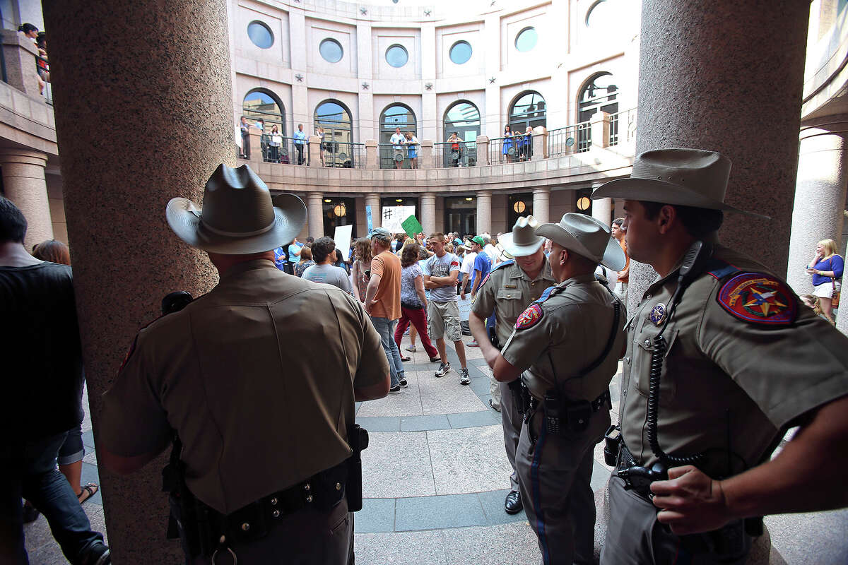 DPS troopers hang out in the hallways as supporters of both sides of the issue fill the Capitol building in Austin as a special committee hears testimony on Senate Bill 2 on July 1, 2013.
