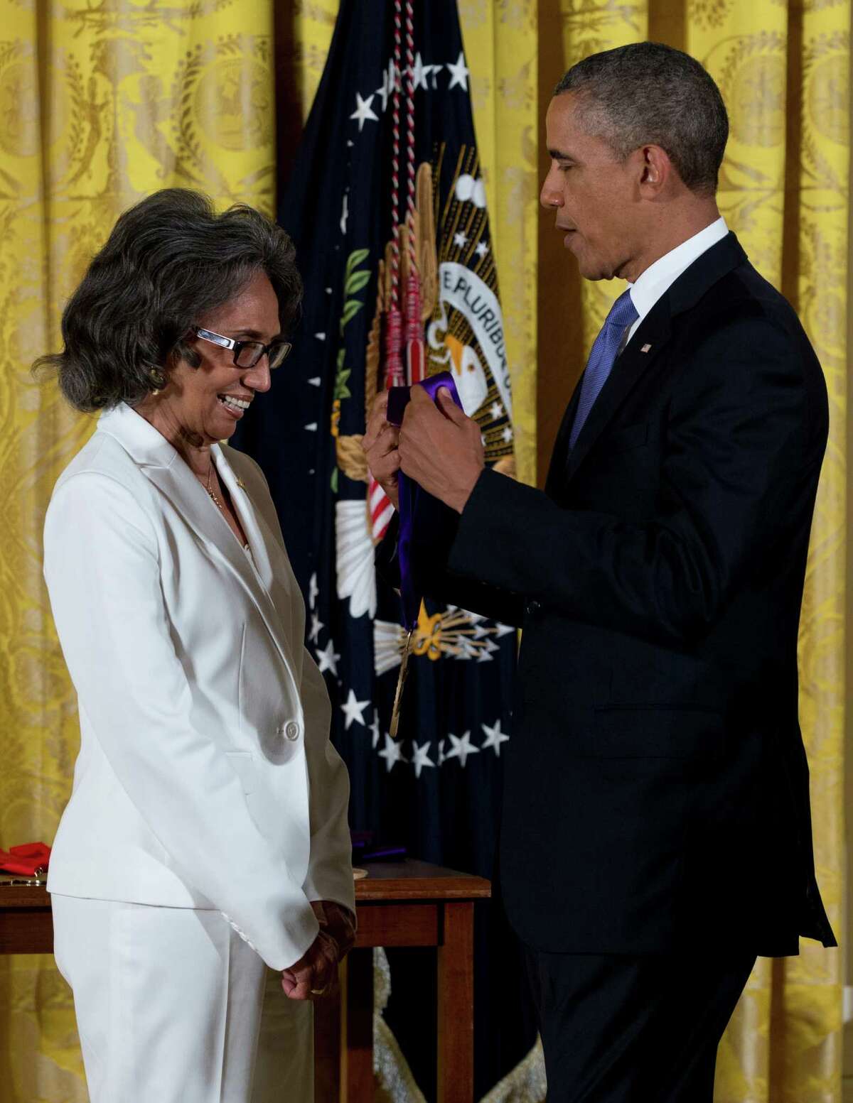 President Barack Obama awards Joan Myers Brown the 2012 National Medal of Arts, for her contributions as a dancer, choreographer, and artistic director, Wednesday, July 10, 2013, during a ceremony in the East Room of White House in Washington. (AP Photo/Carolyn Kaster