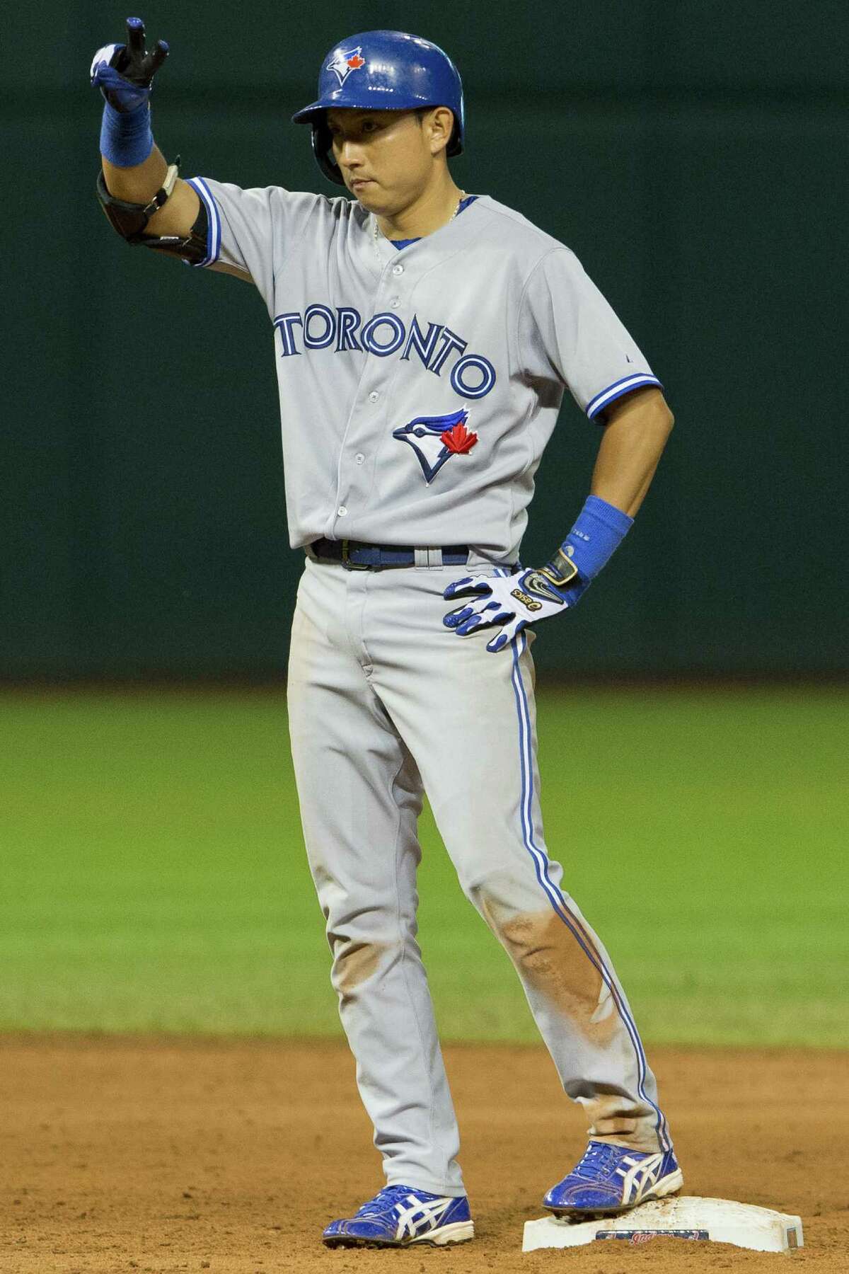 Munenori Kawasaki gestures as his single in the top of the ninth scored three runs for the Blue Jays.
