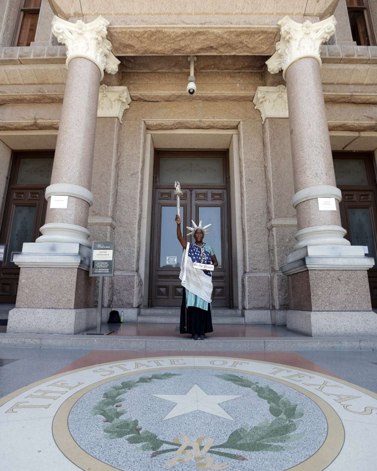 Peace Washington stands outside the Texas Capitol dress as the Statute of Liberty, Wednesday, July 10, 2013, in Austin, Texas. The Texas House approved HB 2 with a third and final vote Wednesday, which would require doctors to have admitting privileges at nearby hospitals, only allow abortions in surgical centers, dictate when abortion pills are taken and ban abortions after 20 weeks. (AP Photo/Eric Gay)