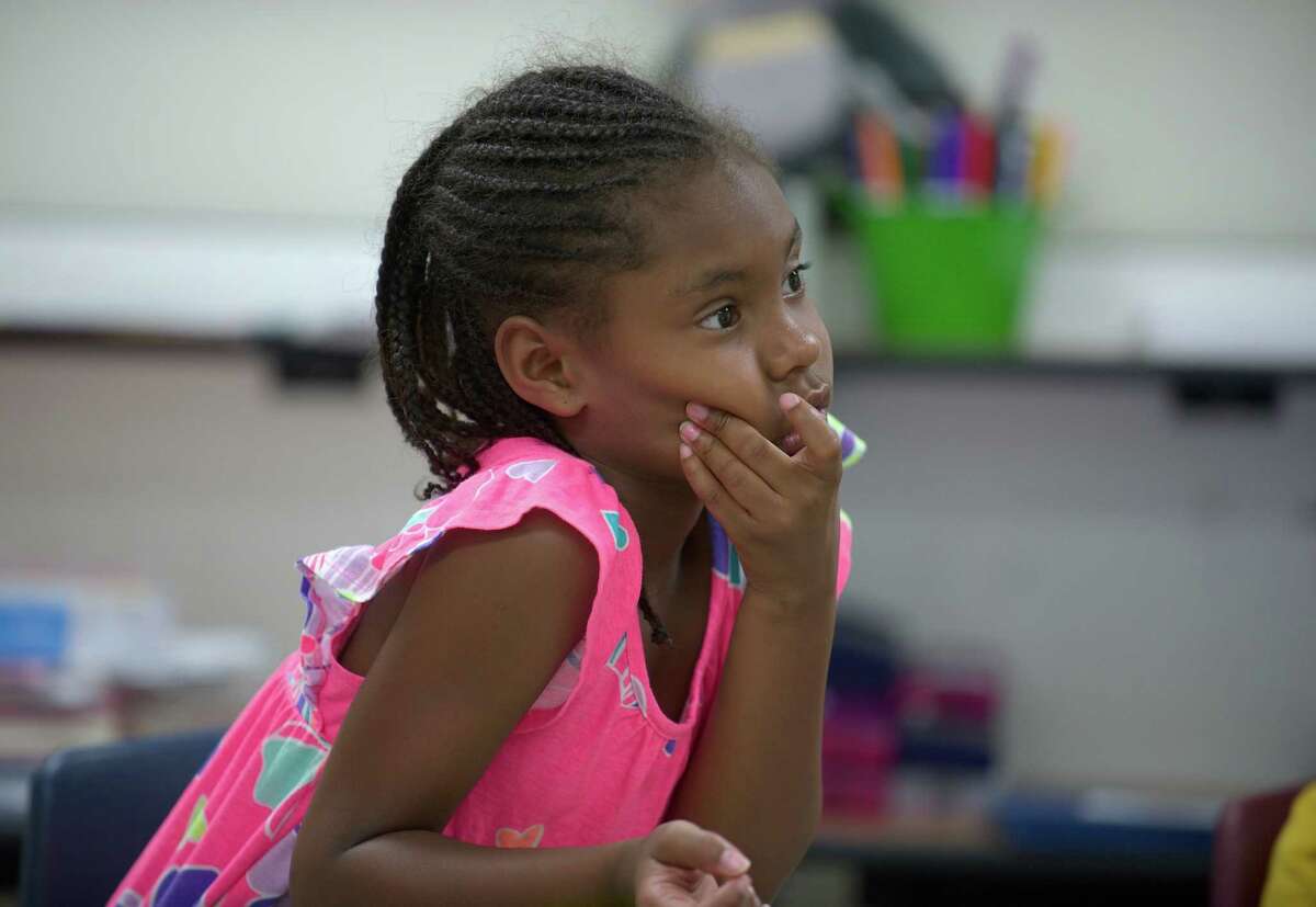 Dichelle Swift, age 6, listens to a question during "On With Learning" or OWL. It is part of The Sunsational Summer Enrichment Program by the Danbury Public Schools and takes place at Rogers Middle School, in Danbury Conn. Thursday July 11, 2013.