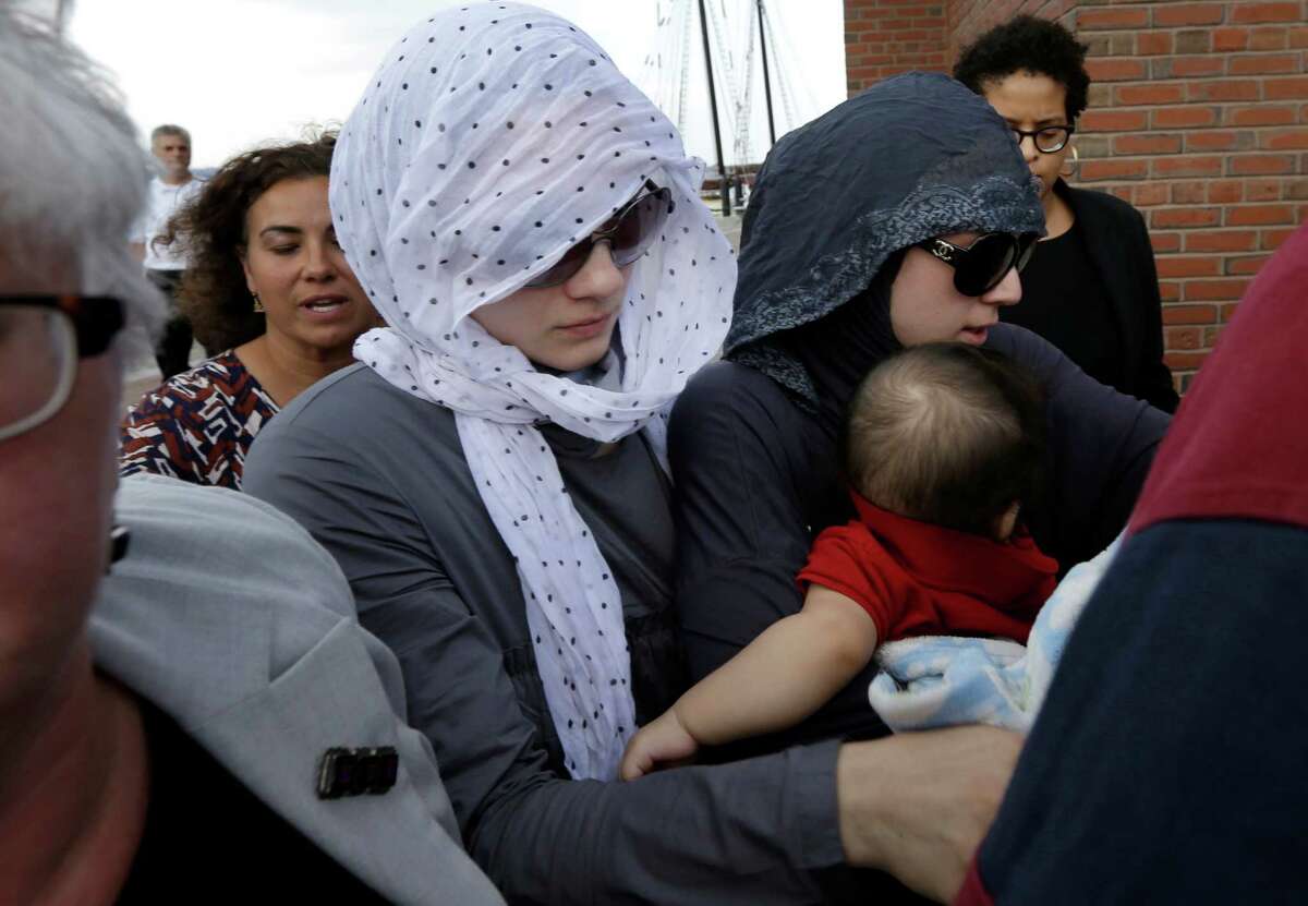 Tsarnaev family members and others depart the federal courthouse in Boston following the arraignment of Boston Marathon bombing suspect Dzhokhar Tsarnaev Wednesday, July 10, 2013, in Boston. The April 15 attack killed three and wounded more than 260. The 19-year-old Tsarnaev has been charged with using a weapon of mass destruction. (AP Photo/Steven Senne)