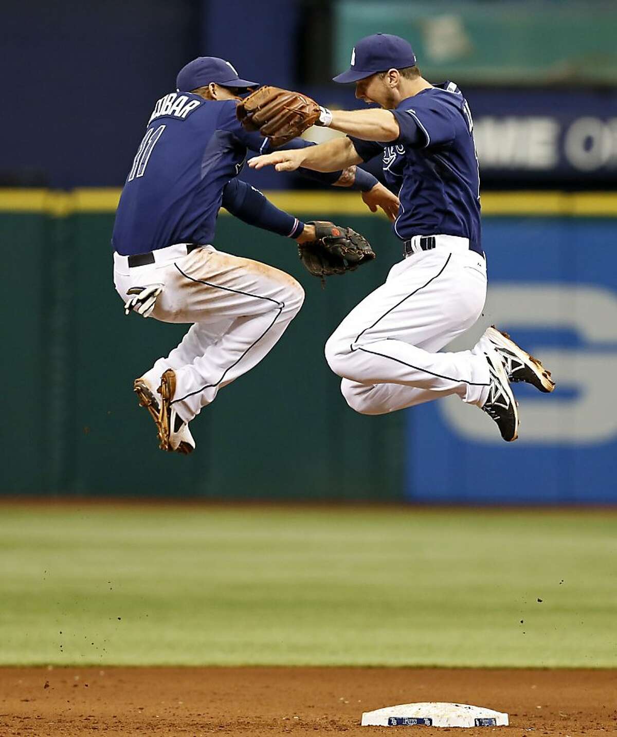 Tampa Bay Rays' Ben Zobrist, right, and Yunel Escobar celebrate at the end of a baseball game against the Minnesota Twins Thursday, July 11, 2013, in St. Petersburg, Fla. The Rays won 4-3. (AP Photo/Mike Carlson)
