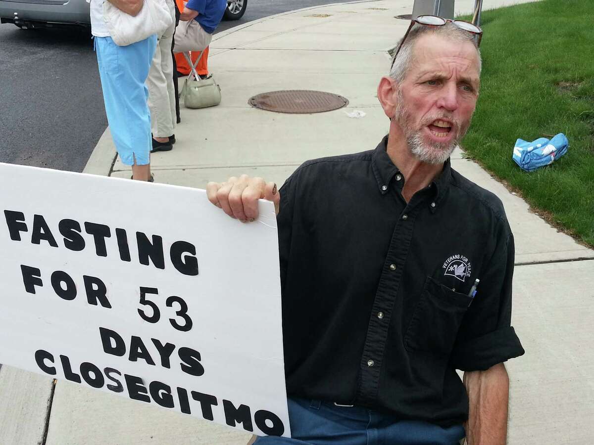 Vietnam veteran Elliott Adams, 66, of Sharon Springs, protest against the Guantanamo Bay U.S. Naval Base prison facility, Wednesday evening, July 10, 2013, on Wolf Road in Colonie, N.Y. Adams has been fasting for over fifty days in protest to the force-feeding of detainees at Guantanamo Bay. Adams has limited himself to 300 calories for eight weeks. HeOs down to 138 pounds from 170. (Dennis Yusko/Times Union)