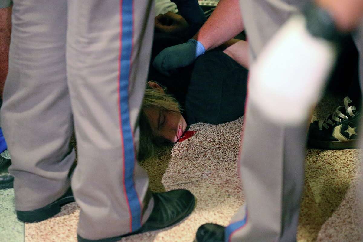 DPS officers stabilize a man after he was injured in the ruckus after the Senate passes abortion legislation on July 12, 2013.