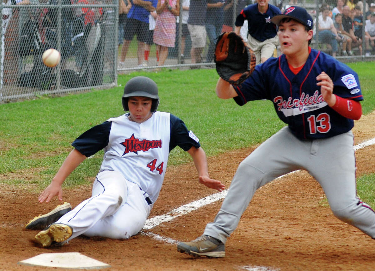 Fairfield National's Mark Vinci gets the ball as Westport's Matt Brown slides into home plate, during District 2 little league action at Unity Park in Trumbull, Conn. on Saturday July 13, 2013.