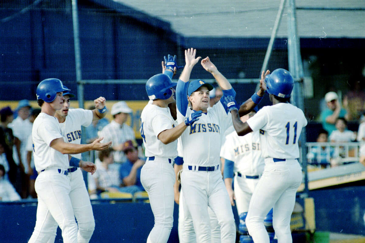 The Missions' Manny Francois (11) is greeted by teammates after his hit ended a 1-0, 26-inning marathon victory over the Jackson Mets on July 16, 1988, at V.J. Keefe Stadium — a game played over three days.