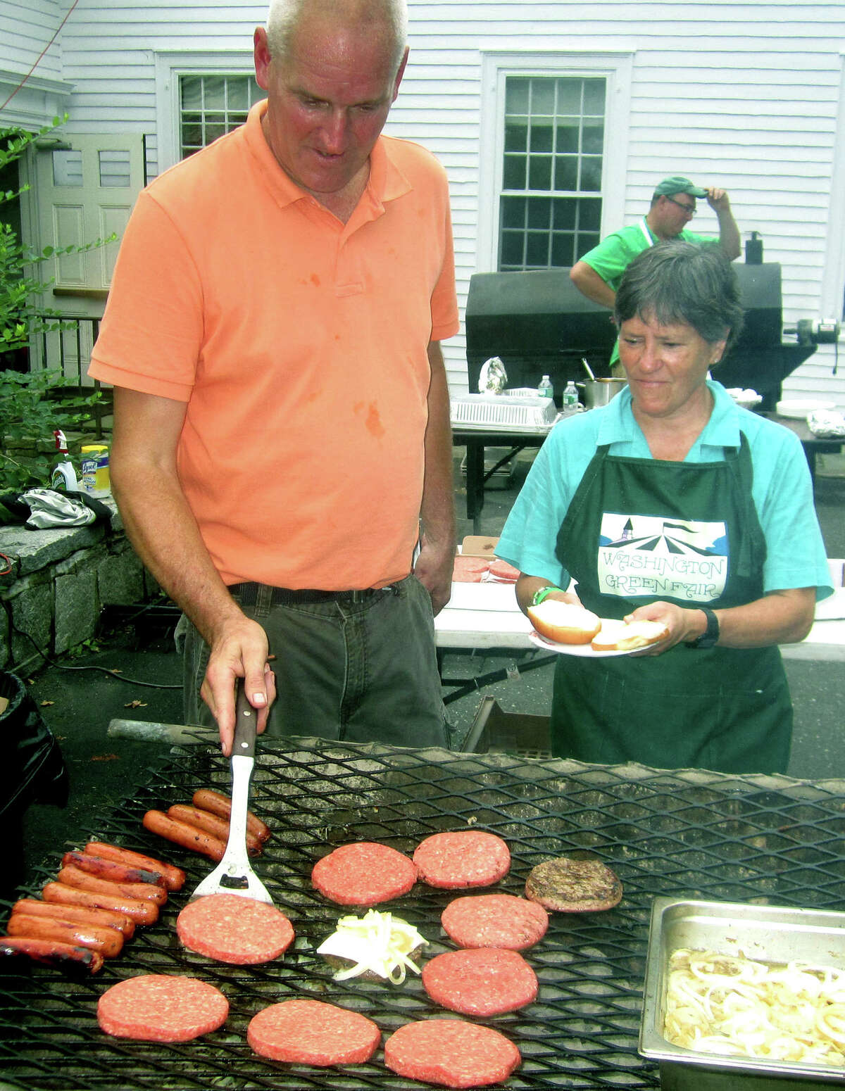 Fifty and going strong The First Congregational Church of Washington's Green Fair turned age 50 Saturday, July 13. Many hundreds of area residents descended on the Washington Green to enjoy a wide variety of attractions including silent and live auctions, a book sale, children's activities and much more. Above, grill man Scott Redstone preps tasty burgers and dogs as volunteers such as Washington town clerk Sheila Anson serve the food up to hungry patrons. For the story and more photos, see the July 26 edition of the Spectrum and visit www.newmilfordspectrum.com.