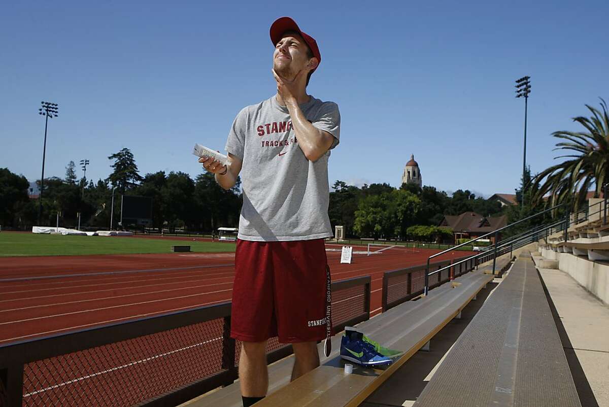 Stanford track member Erik Olson applies sunscreen before running on Cobb track at Stanford University in Palo Alto, Calif., on Friday, July 5, 2013. Erik was diagnosed with skin cancer at age 20. Stanford recently launched a program to encourage it's athletes to lather up with sunscreen and practice safe habits when it comes to sun exposure.