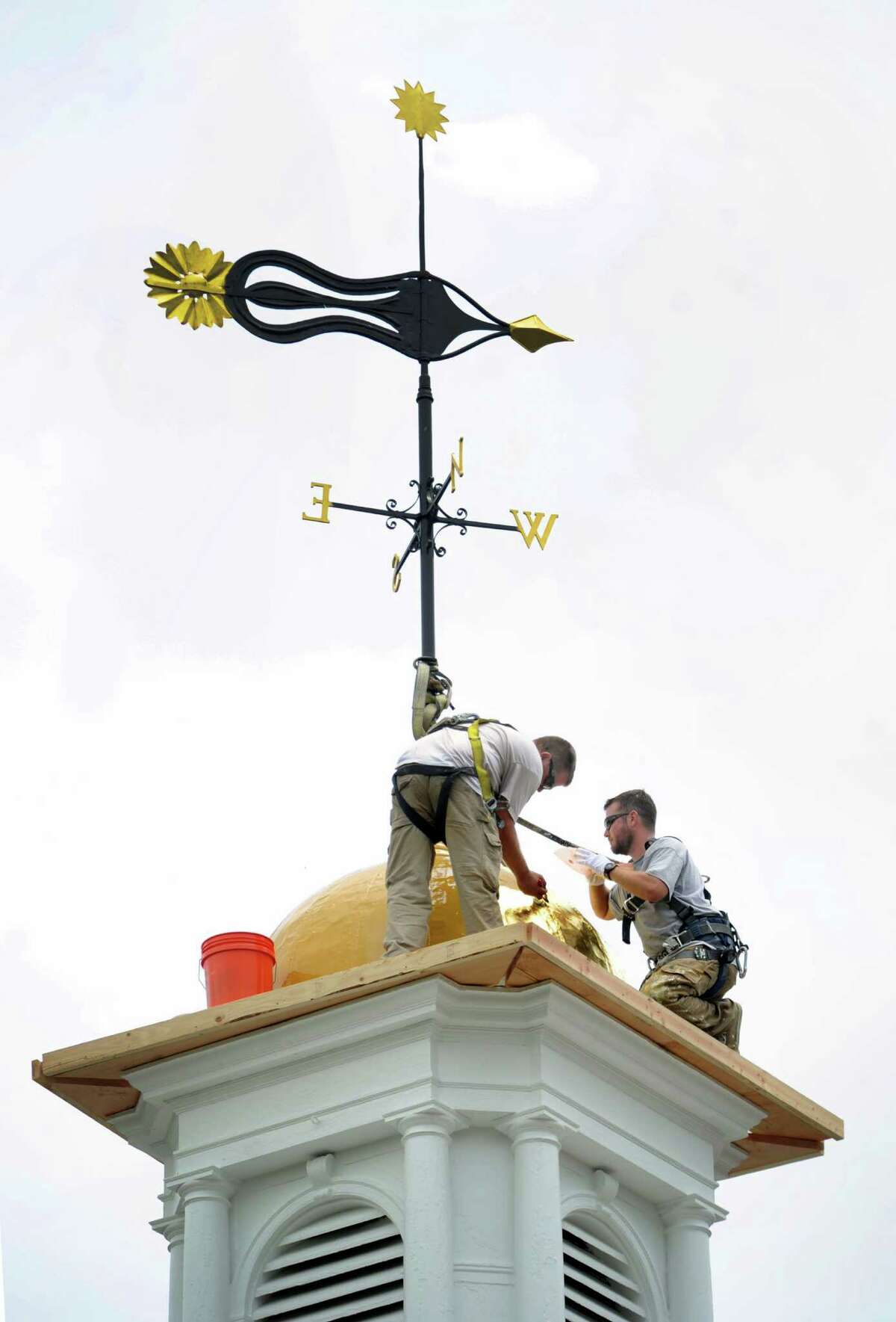 Paul Bastiaanse, left, and Dan Smith, Valley Restoration of Torrington, Conn., work on the cupola at the Edmond Town Hall in Newtown, Conn., Wednesday, July 10, 2013.