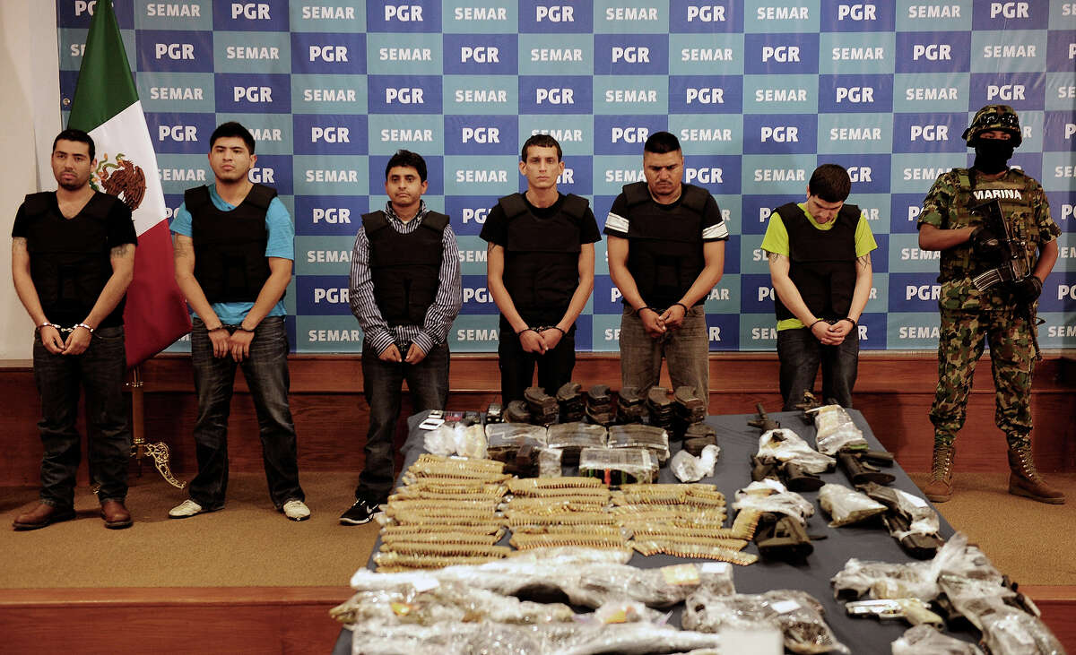 Salvador Alfonso Martinez, aka "Ardilla", (3rd-L), alleged member of the Los Zetas Cartel and alleged mastermind of the San Fernando slaughter, is presented with accomplices to the media at the General Attorney's offices in Mexico City, on October 8, 2012. Some 50,000 people have been killed in mostly drug-related violence in Mexico since 2006, when the government launched a massive military crackdown on the powerful cartels, which also battle each other over territory.
