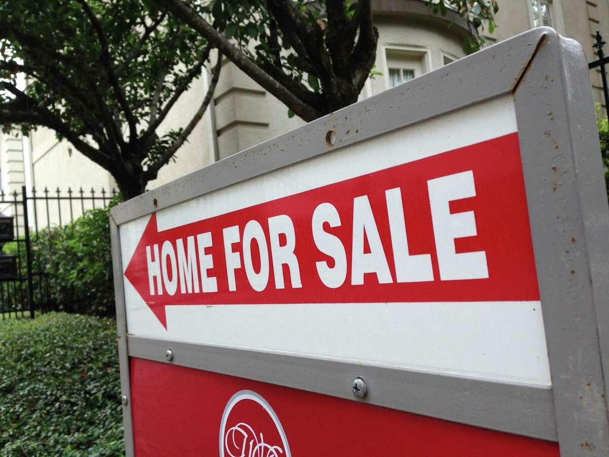 A sign points to a house for sale in the Galleria area of Houston. Homes selling for $250,000 to $1 million and above registered the biggest gains in sales volume in August, the Houston Association of Realtors reported Tuesday.