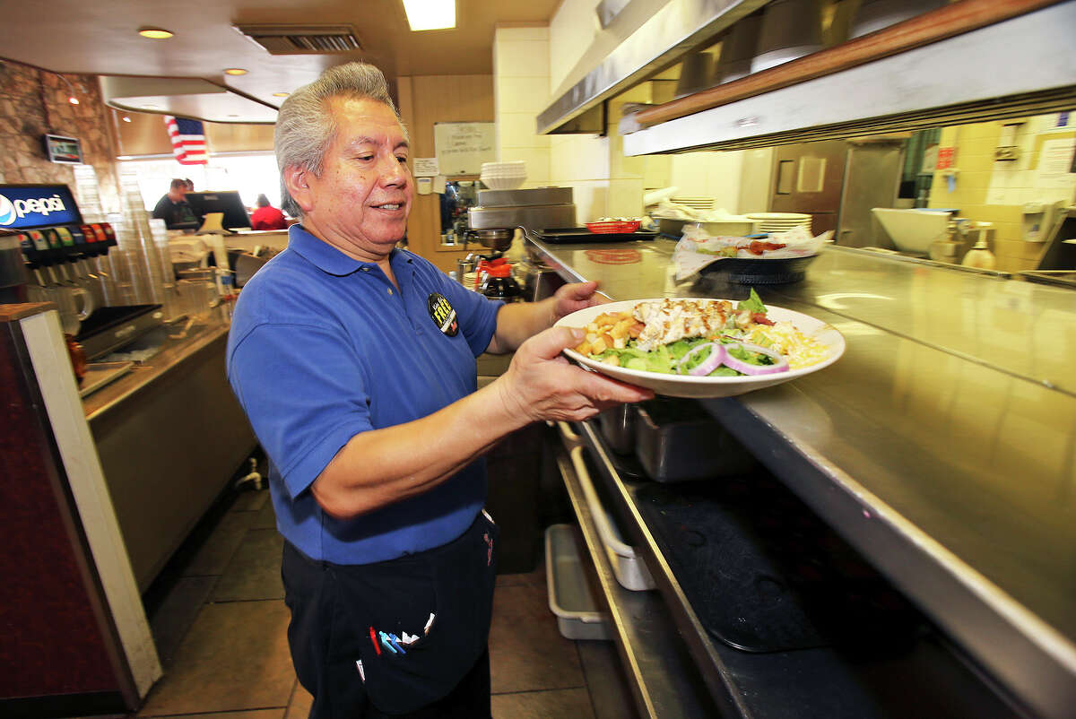 Lupe Plata works at his job as a server at Jim's Reataurant on Broadway near downtown on July 16, 2013.