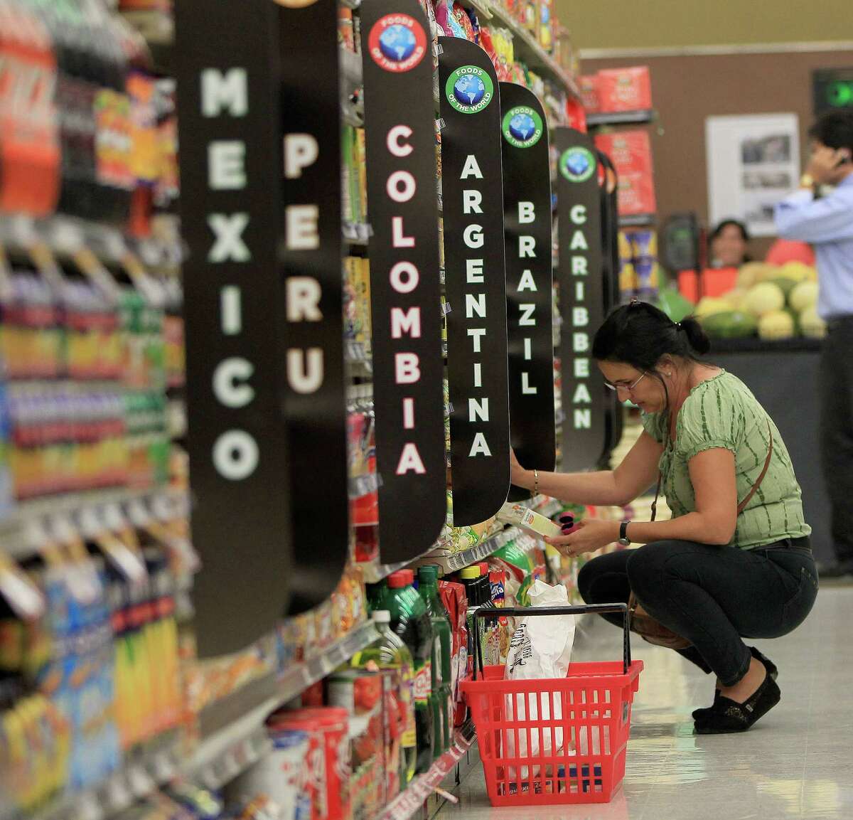 A customer shops on Wednesday along the Foods of the World aisle during the grand opening of the Fiesta Market Place in Sugar Creek. The store has a number of firsts for the Fiesta chain.