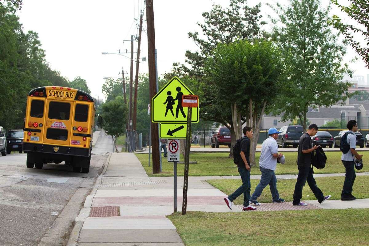 Students arrive to the High School for Law Enforcement and Criminal Justice Wednesday, May 25, 2011, in Houston. Houston ISD is proposing to change the start and end times of schools -- to better coordinate bus schedules and save about $1.2 million. The proposal means most high schools would have to start at 7:45 a.m. That will be a big change for students at several schools, including those at the High School for Law Enforcement and Criminal Justice, which now starts at 8:30 a.m.