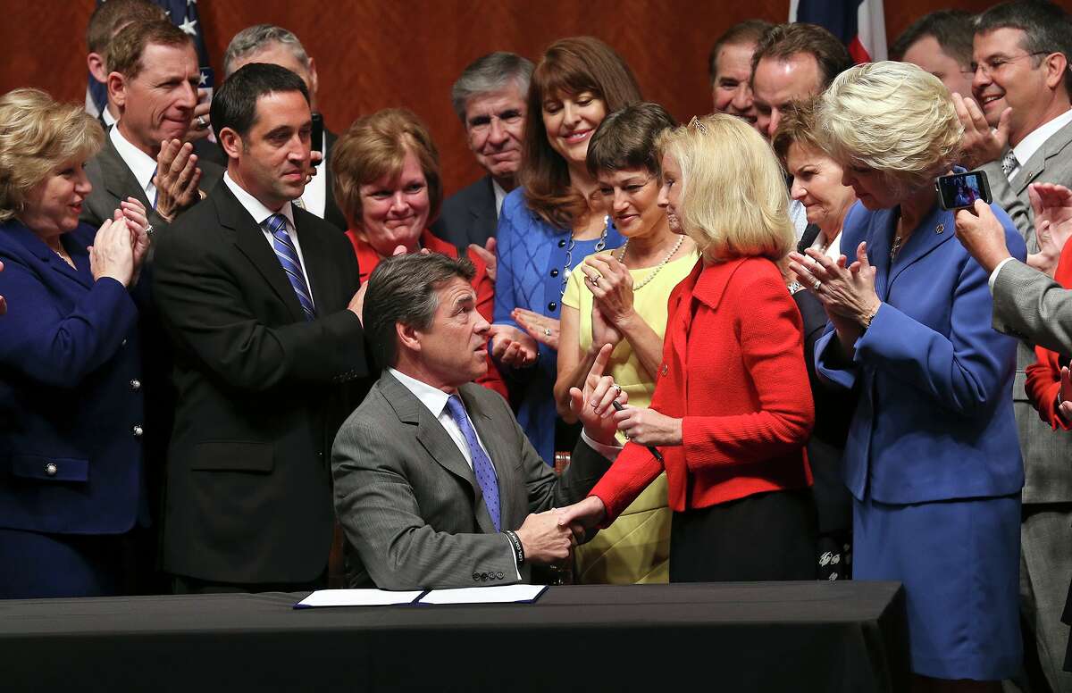 Gov. Rick Perry congratulates state Rep. Jodie Laubenberg, R-Parker, Thursday after signing into law the abortion-restrictions bill she helped sponsor. Texas now has some of the strictest abortion laws in the nation.