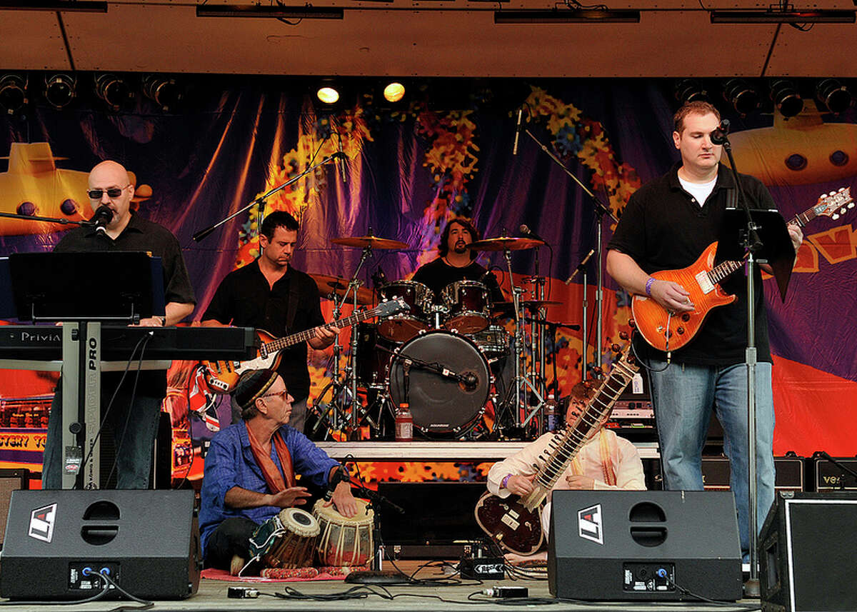 Musicians perform at last year's Beatles festival, Danbury Fields Forever, at Ives Concert Park in Danbury. Look closely and you'll see some yellow submarines on the backdrop. This year's festival, Saturday, Aug. 3, features 10 bands, food, vendors, bouncy attractions for kids to play on, and more.
