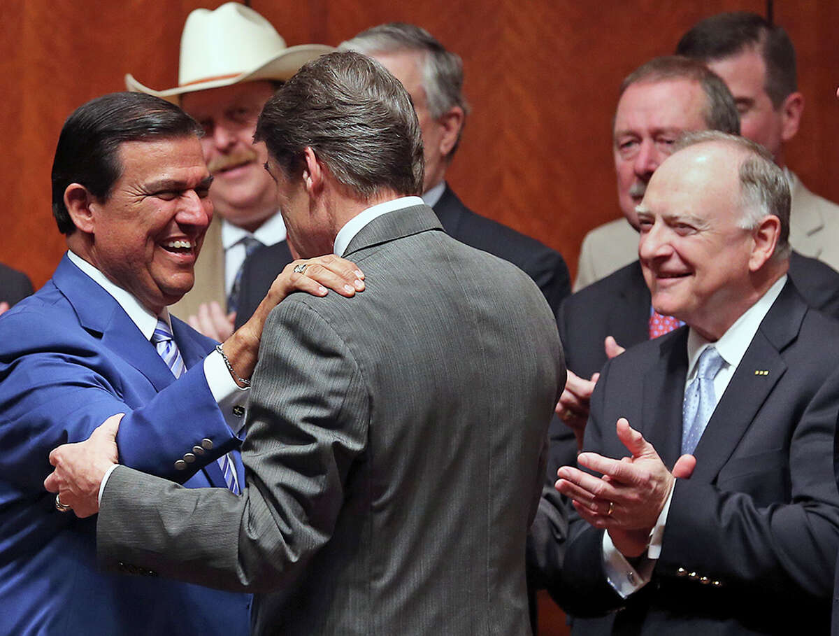 Again wearing his blue coat, Senator Eddie Lucio D-Brownsville, greets Governor Rick Perry before the signing into law of the abortions restrictions bill on July 18, 2013.