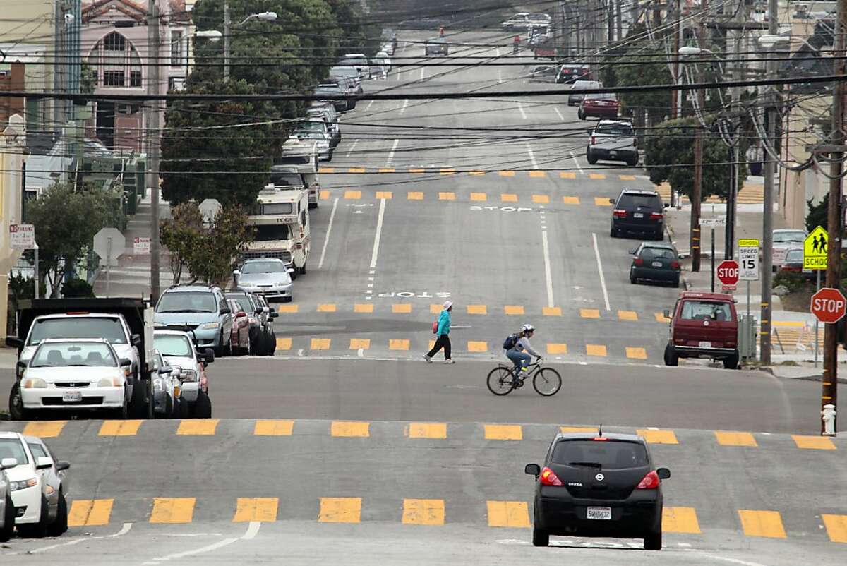 A pedestrian crosses Kirkham street above 47th. San Francisco's Sunset neighborhood was once dotted with houses fashioned out of retired horse cars only one remains at 1632 Great Highway between Lawton and Moraga. Friday July 19, 2013.