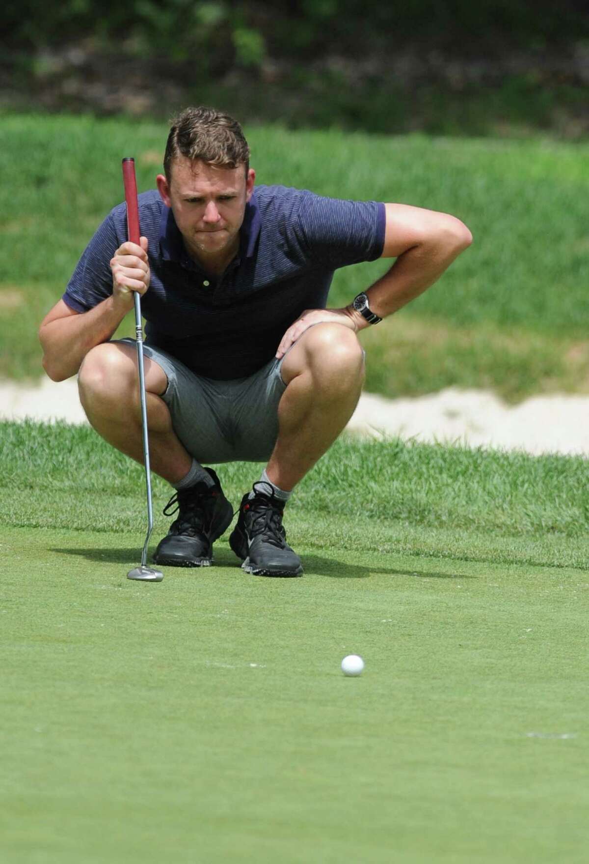 Michael Fisher lines up a putt during day two of the Danbury Amateur Golf Championship at Richter Park Golf Club in Danbury, Conn. on Saturday, July 21, 2013.