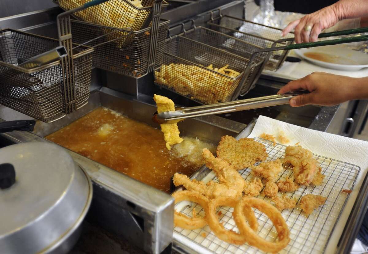 Frying up fried frogs legs, onion rings and catfish at Vautrot's Cajun Cuisine at 13350 Hwy 105. Photo taken Tuesday, February 7, 2012 Guiseppe Barranco/The Enterprise