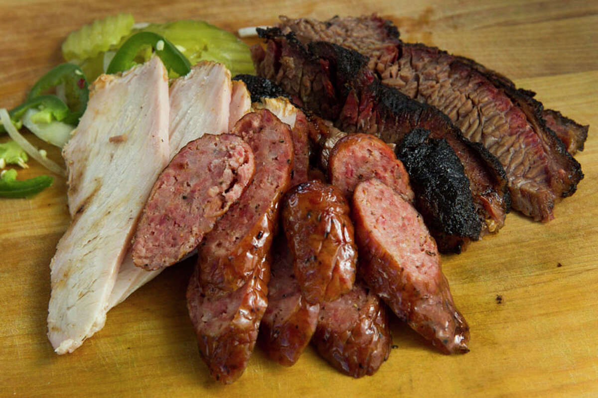 The three-meat plate is shown at Corkscrew BBQ.