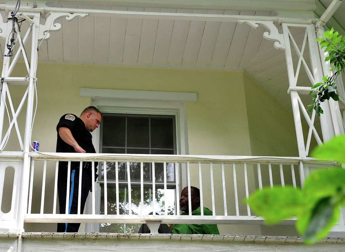 Danbury Police Officer Ken Utter tells a squatter to leave the octagonal house, which has been abandoned for a little over a year, in Danbury, Conn. Monday, July 22, 2013.