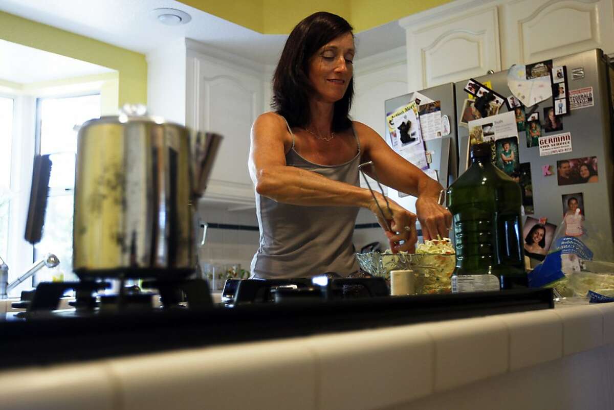 Jennifer Fitzgerald prepares a healthy meal for her family on Wednesday, July 17, 2013 in Concord, Calif.