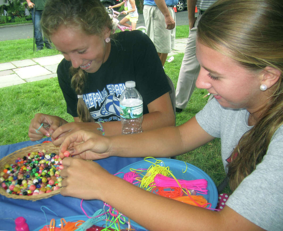 Caroline Kelly, left, and Sarah Stratton relish the opportunity to show their skills at handmade jewelry to peddle during the Washington Congregational Church's annual Green Fair, July 13, 2013.