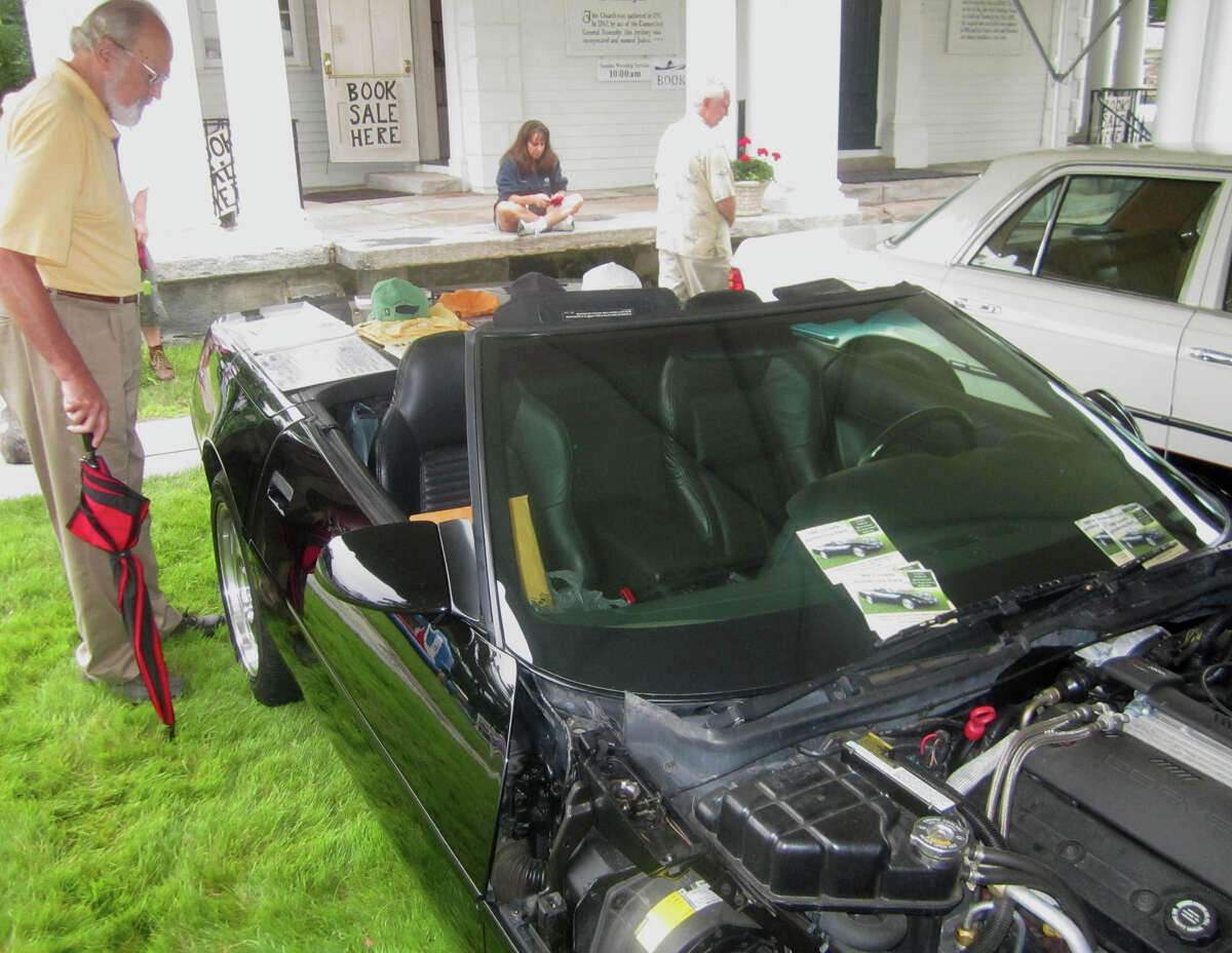 Carlos Canal of Washington perhaps wonders how a Corvette for raffle would suit his tastes during the Washington Congregational Church's annual Green Fair, July 13, 2013.