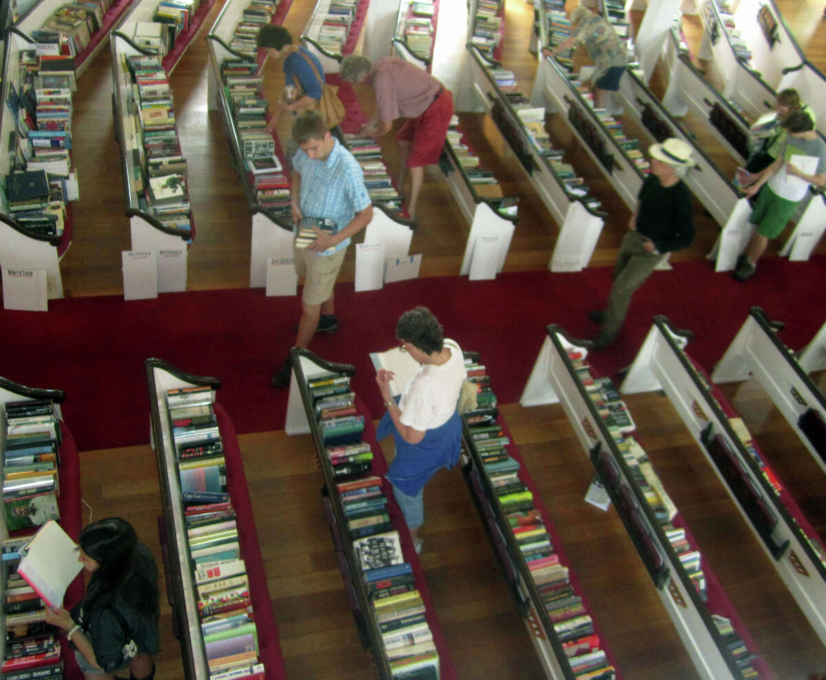 An expansive book sale in the church sanctuary lures many an avid reader during the Washington Congregational Church's annual Green Fair, July 13, 2013.
