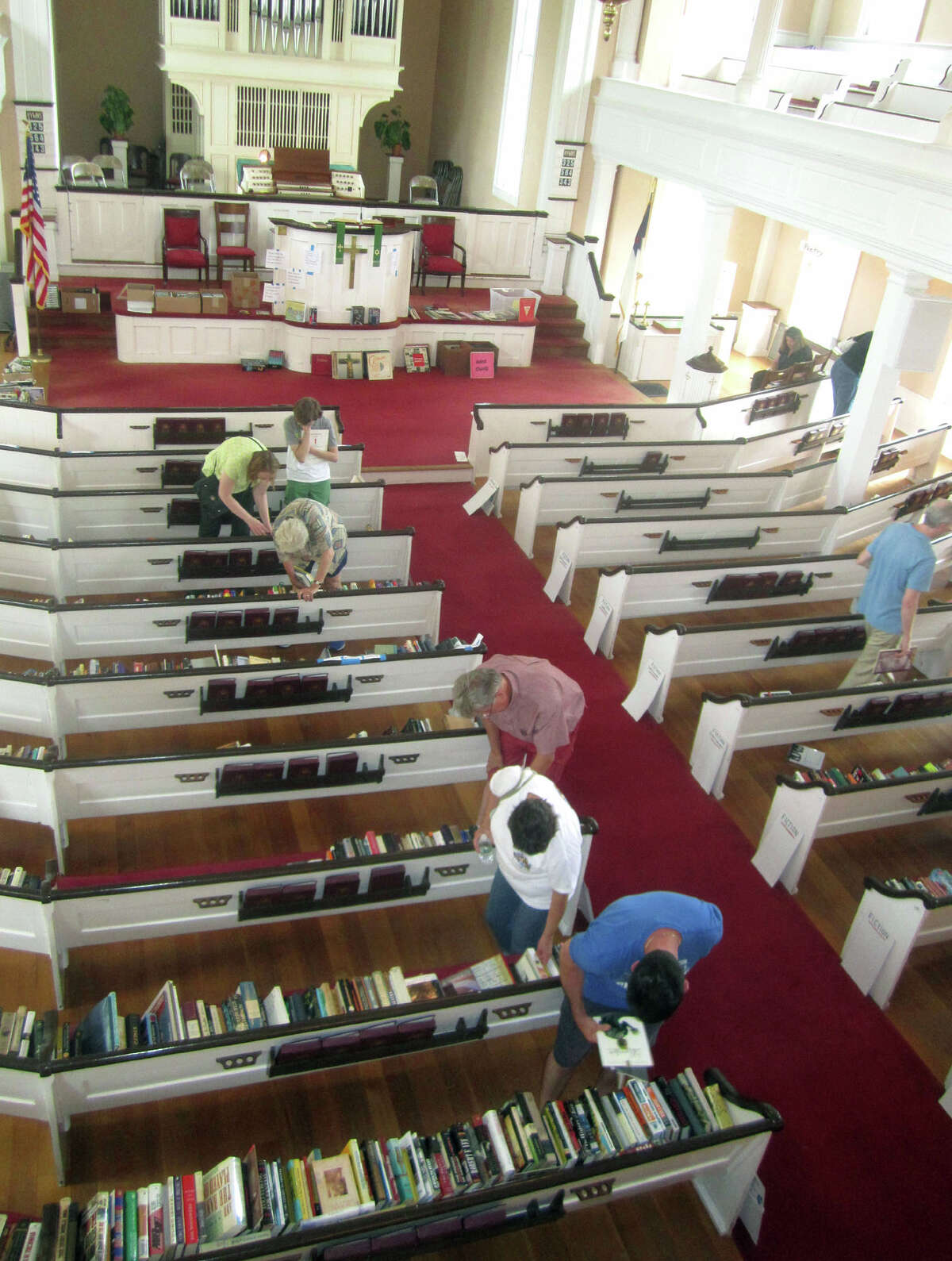 An expansive book sale lures many an avoid reader to the church sanctuary during the Washington Congregational Church's annual Green Fair, July 13, 2013.