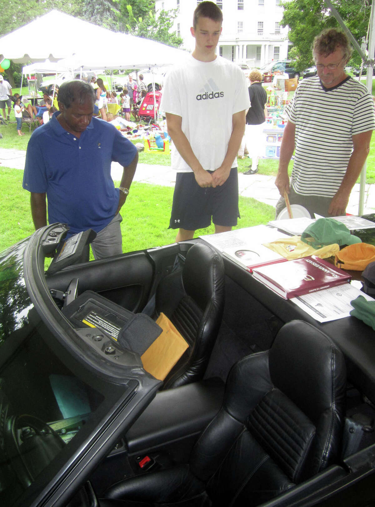 A vintage Corvette for auction attracts a steady stream of inquisitive patrons during the Washington Congregational Church's annual Green Fair, July 13, 2013.