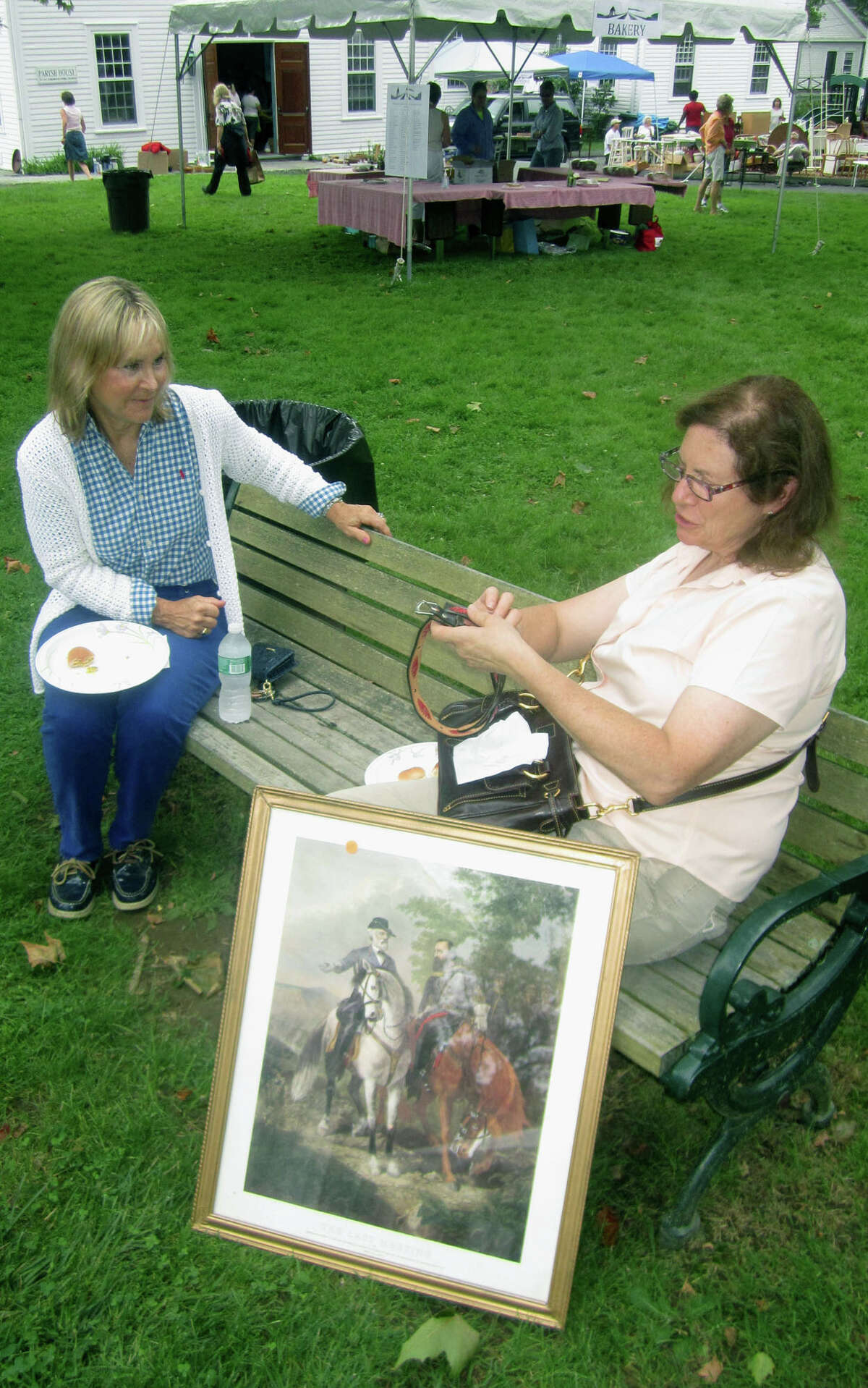 Renee Bradley of Sherman relaxes with Renee Collins of Sherman shortly after purchasing the painting,